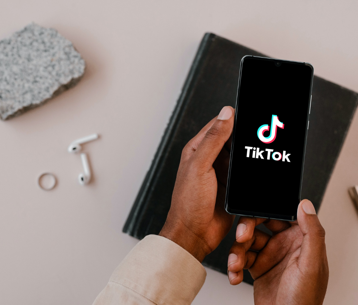 Hand holding phone with TikTok Logo - The Do's and Don'ts of TikTok For Business